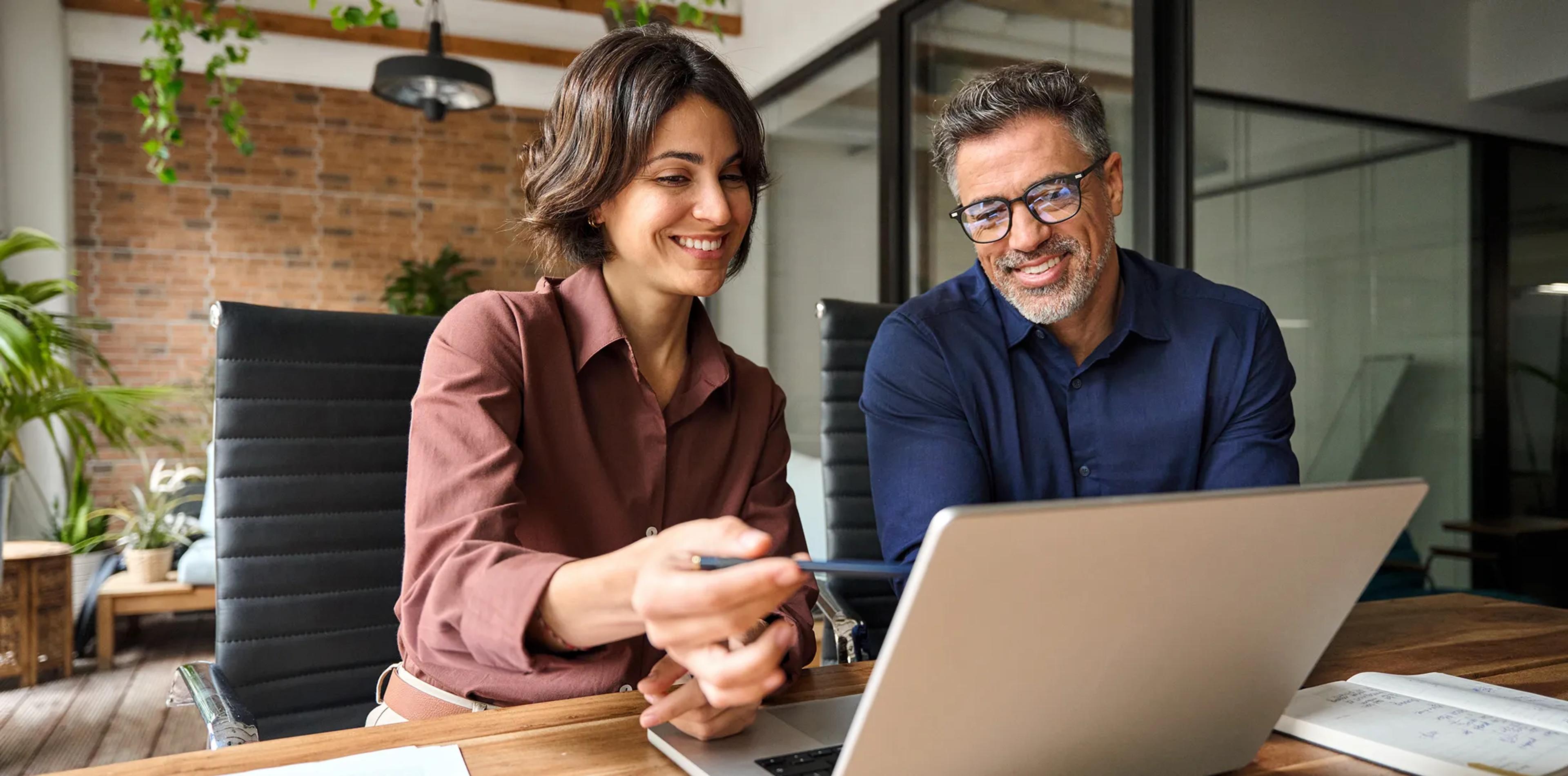 A woman and a man looking at a computer screen together