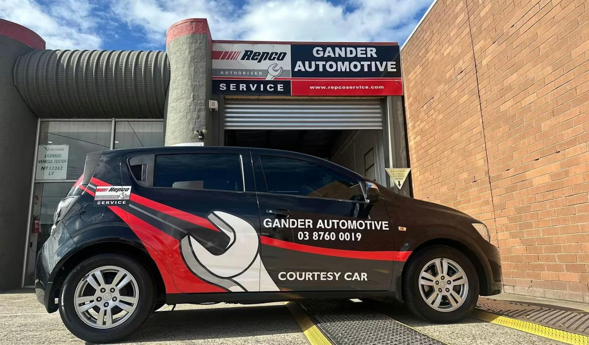 Mechanics working on car
