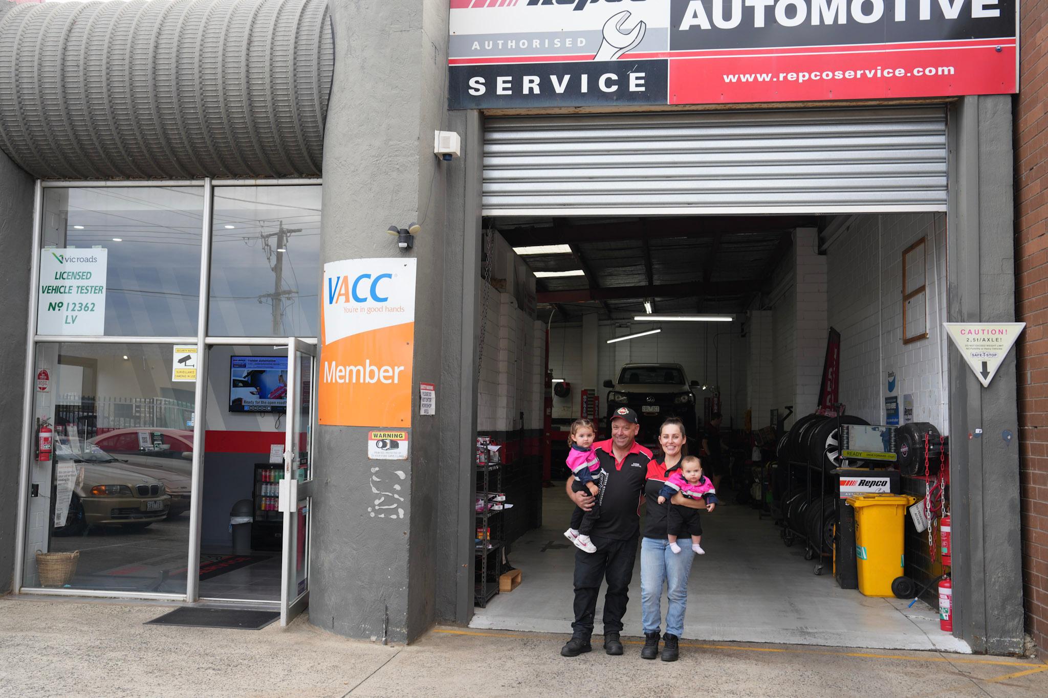 Mechanics working on car