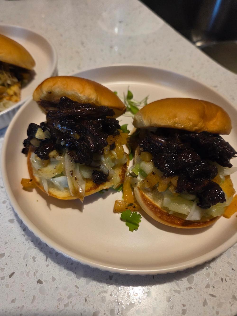 Bespoke braised short rib sliders by Chef Kimberly Kee of Saucy Kim K, featuring a unique cantaloupe chutney, crisp fennel slaw, and a rich thyme reduction on toasted brioche. Luxury private dining and boutique catering available in Rhode Island, Massachusetts, Connecticut, and New York.
