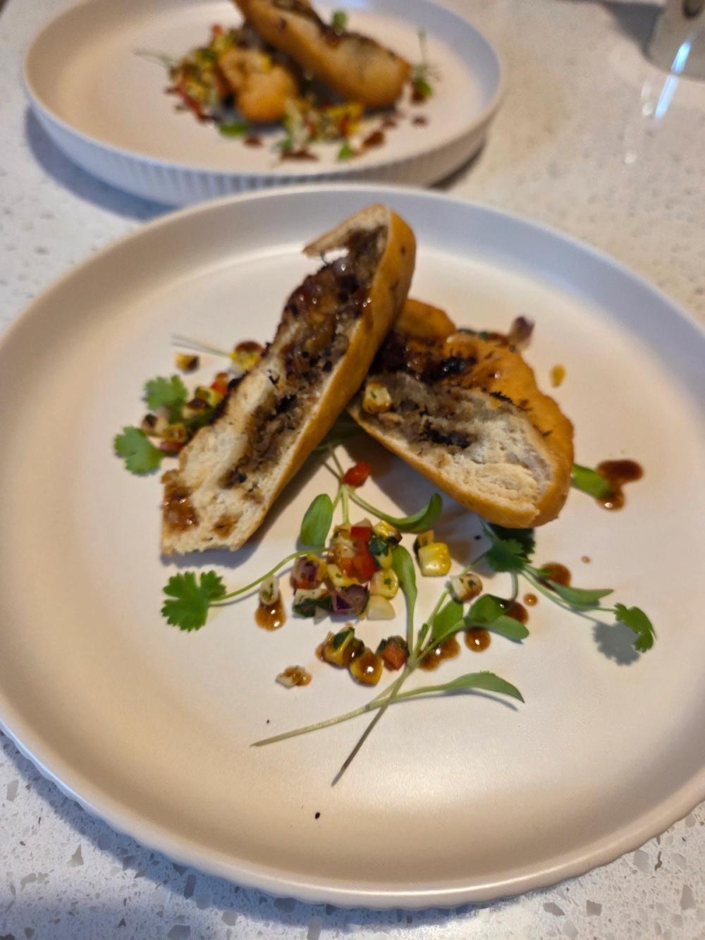 Bespoke Caribbean fusion appetizer by Chef Kimberly Kee: Honey Jerk Chicken stuffed inside artisan fried festival dough, garnished with fresh corn salsa, microgreens, and a tamarind gastrique. Luxury private dining and catering service serving Newport RI, Greenwich CT, and Boston MA.