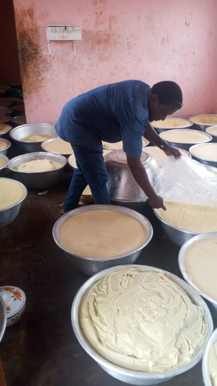 Batter being prepared in large basins for a community meal
