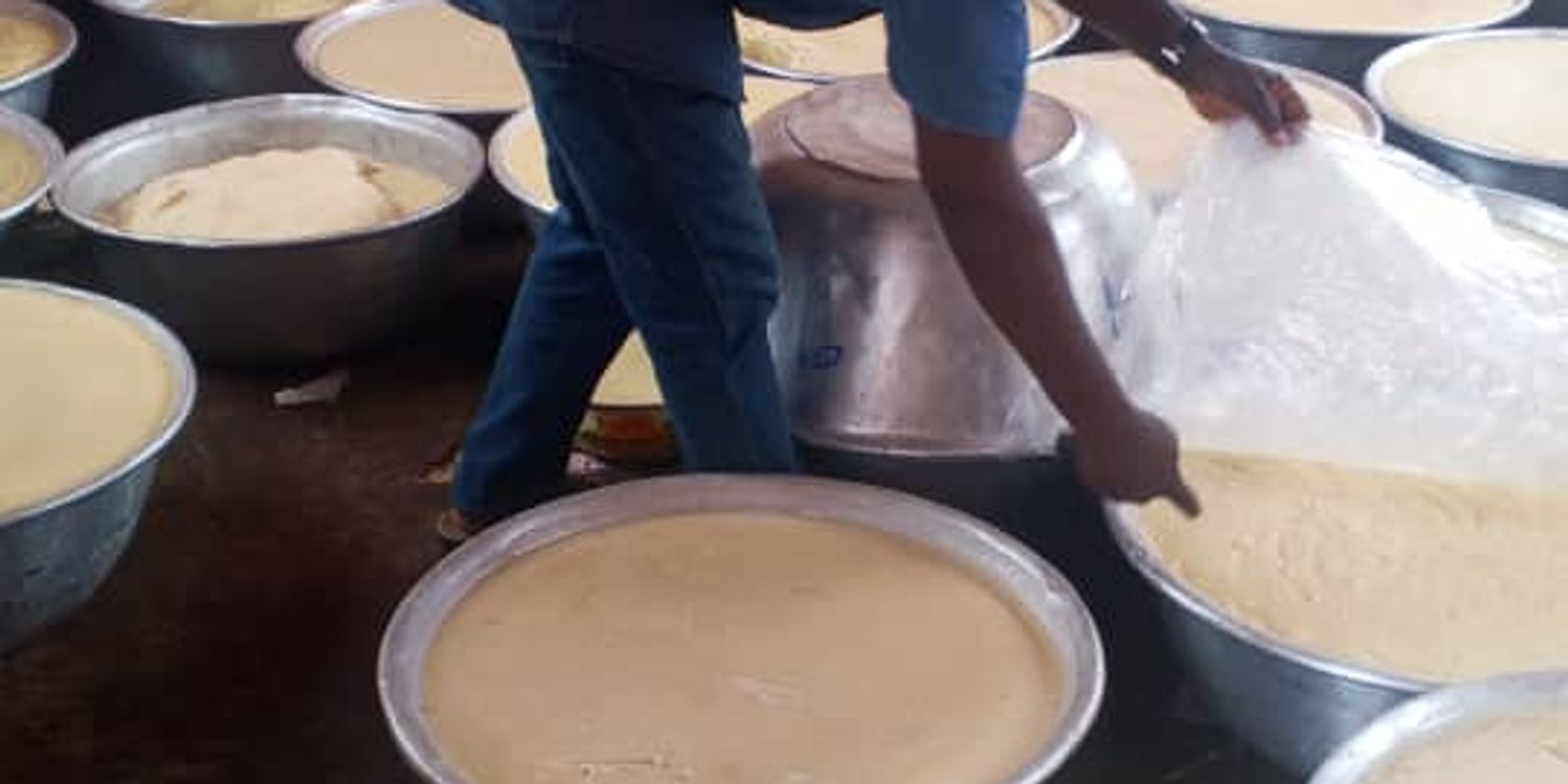 Batter being prepared in large basins for a community meal