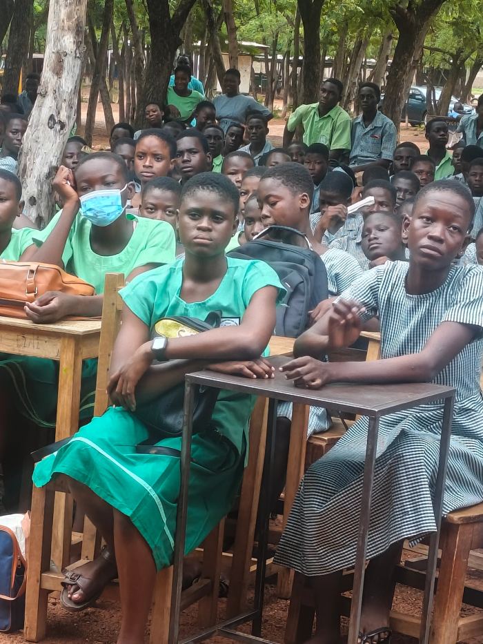 Pupils in school uniform seated at their desks