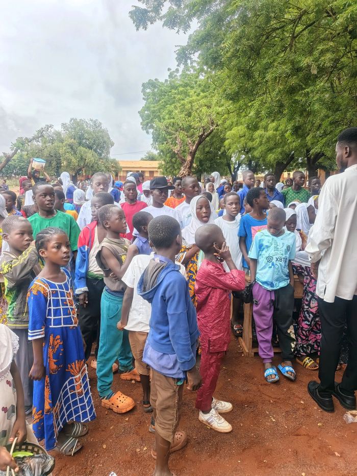 A crowd of pupils gathered outside their school