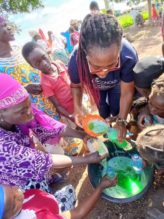 Women mixing soap in bowls during a training session