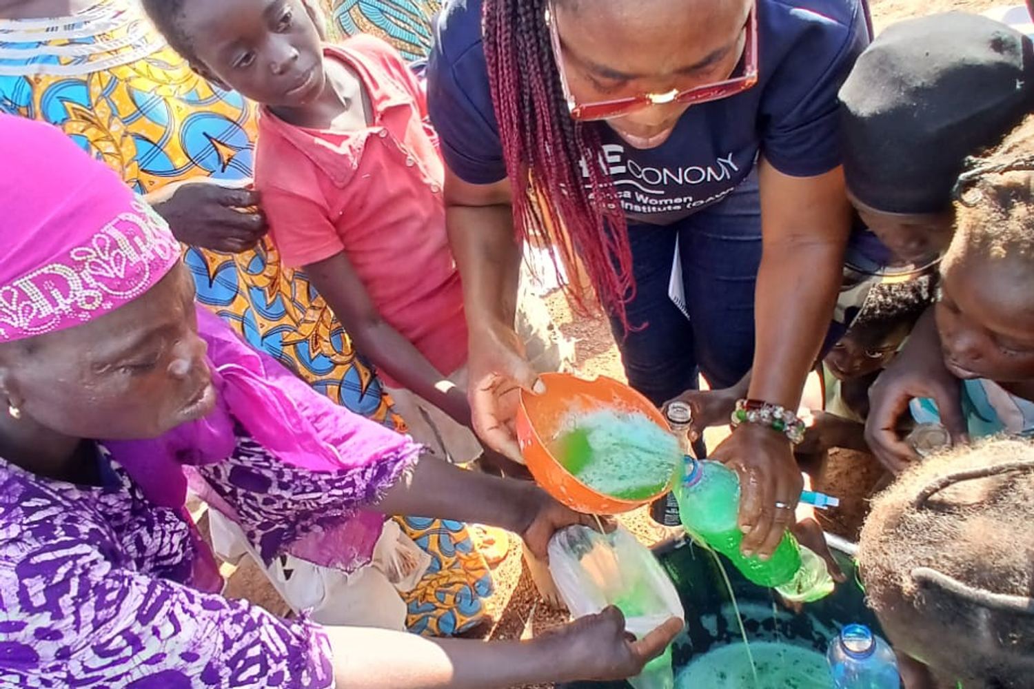 Women mixing soap in bowls during a training session