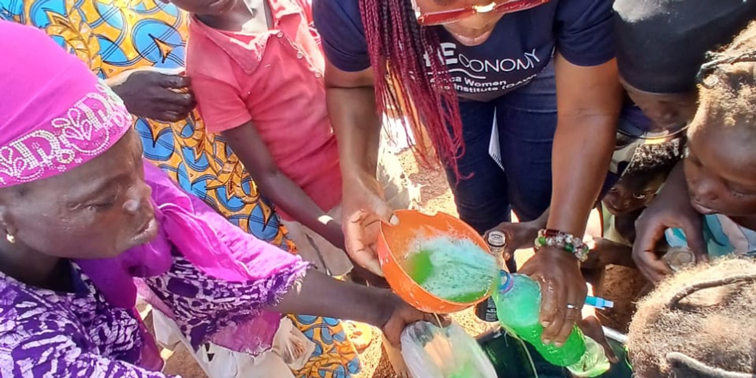Women mixing soap in bowls during a training session