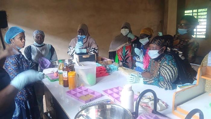 Women at a soap-making training, moulds and ingredients laid out