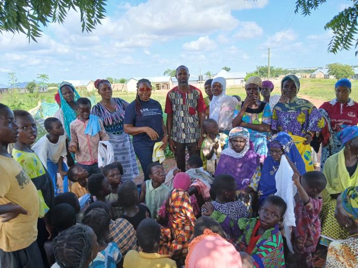 Women and children gathered together at a community meeting