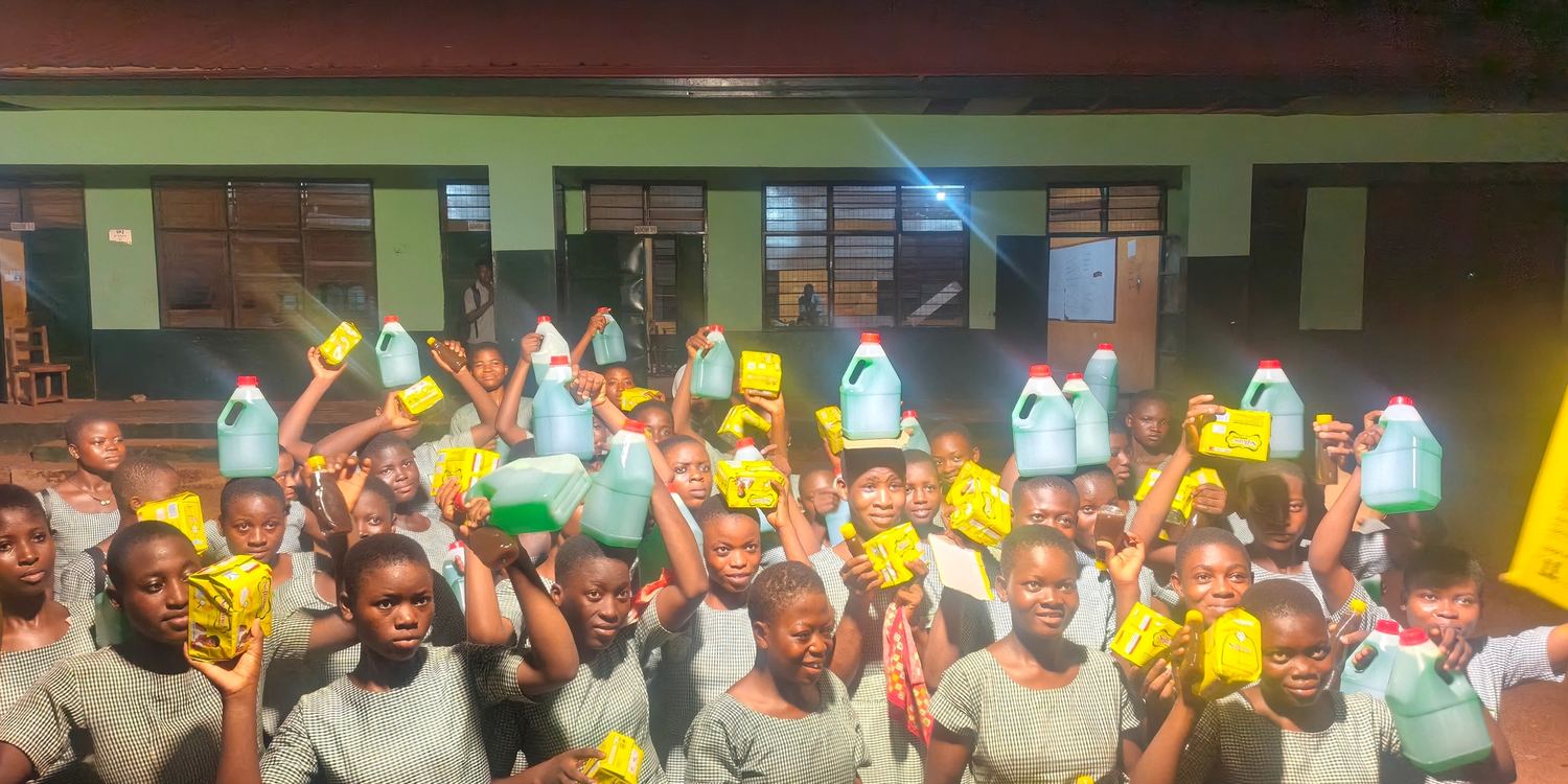A schoolyard full of children with the supplies they have just received