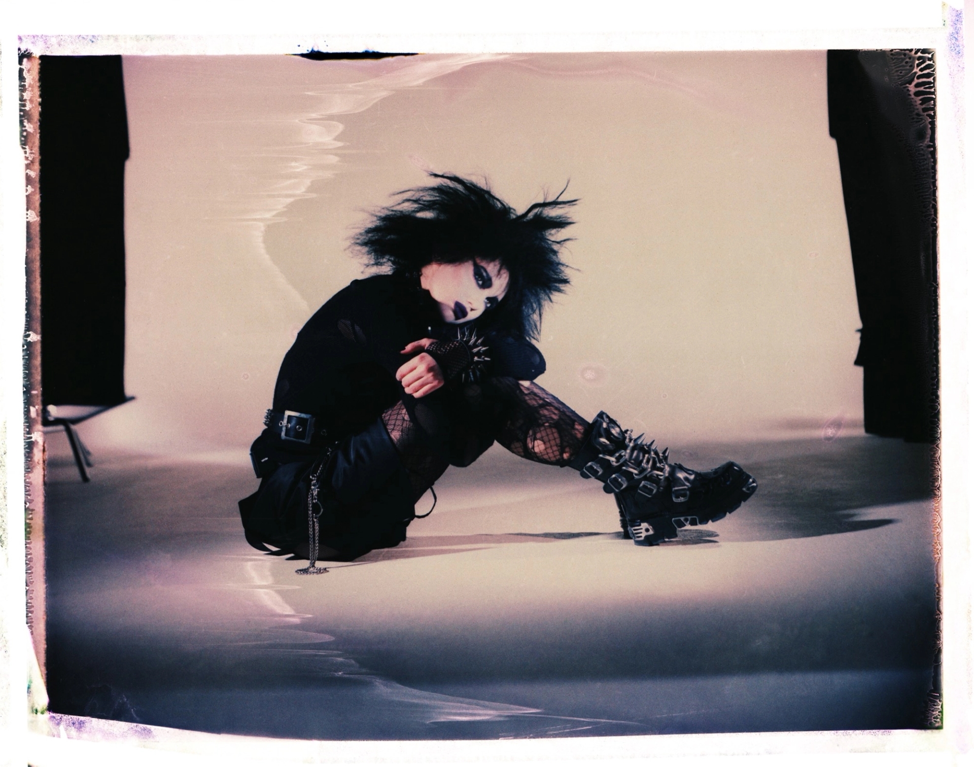 knitwear and top worn as skirt PRADA belt and cuffs THE LONDON LEATHERMAN fishnet top, choker, and belt chain STYLIST'S OWN boots NEW ROCK tights FALKE