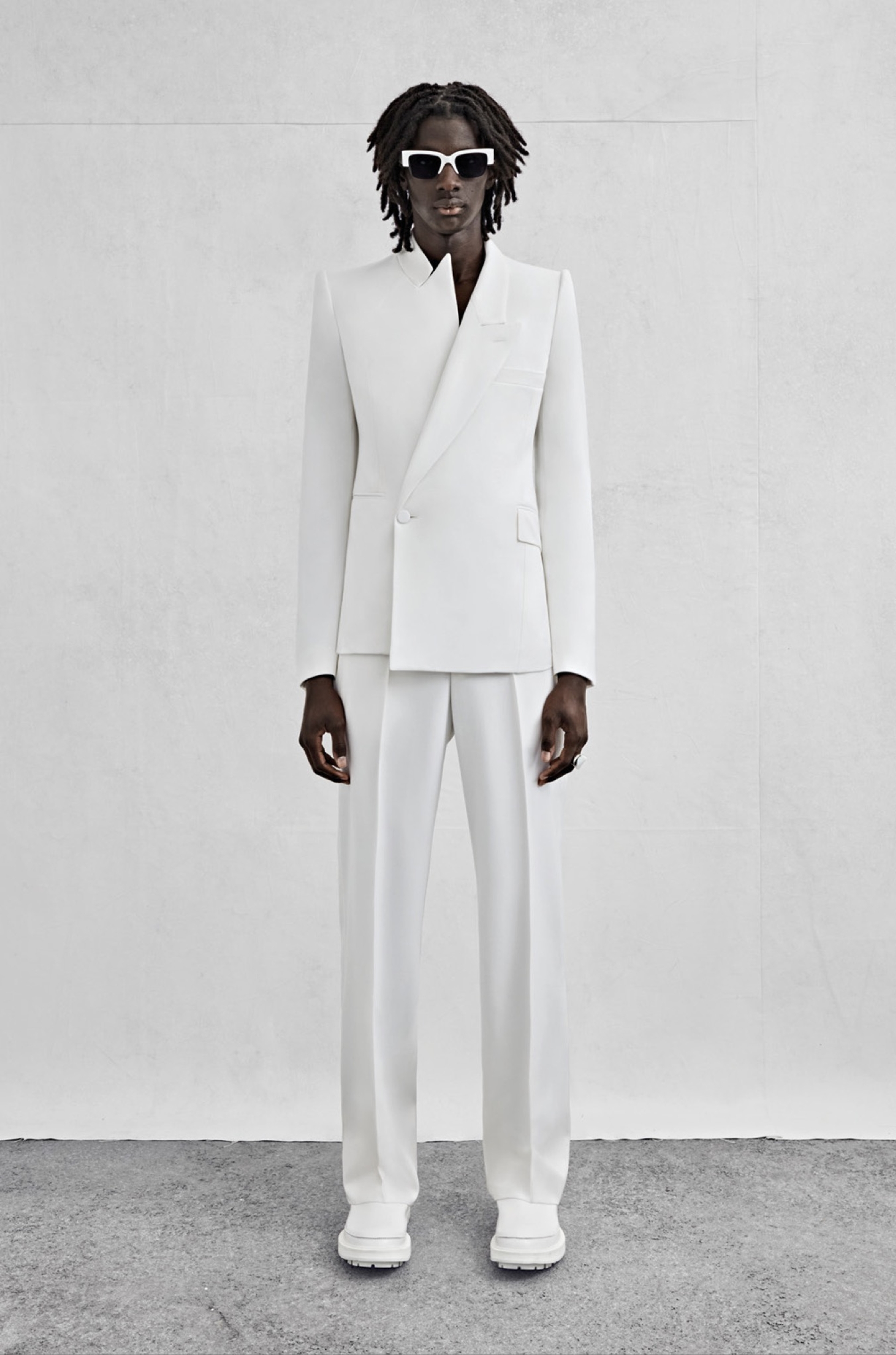 An asymmetric tailored jacket and wide-legged trousers in ivory grain de poudre.