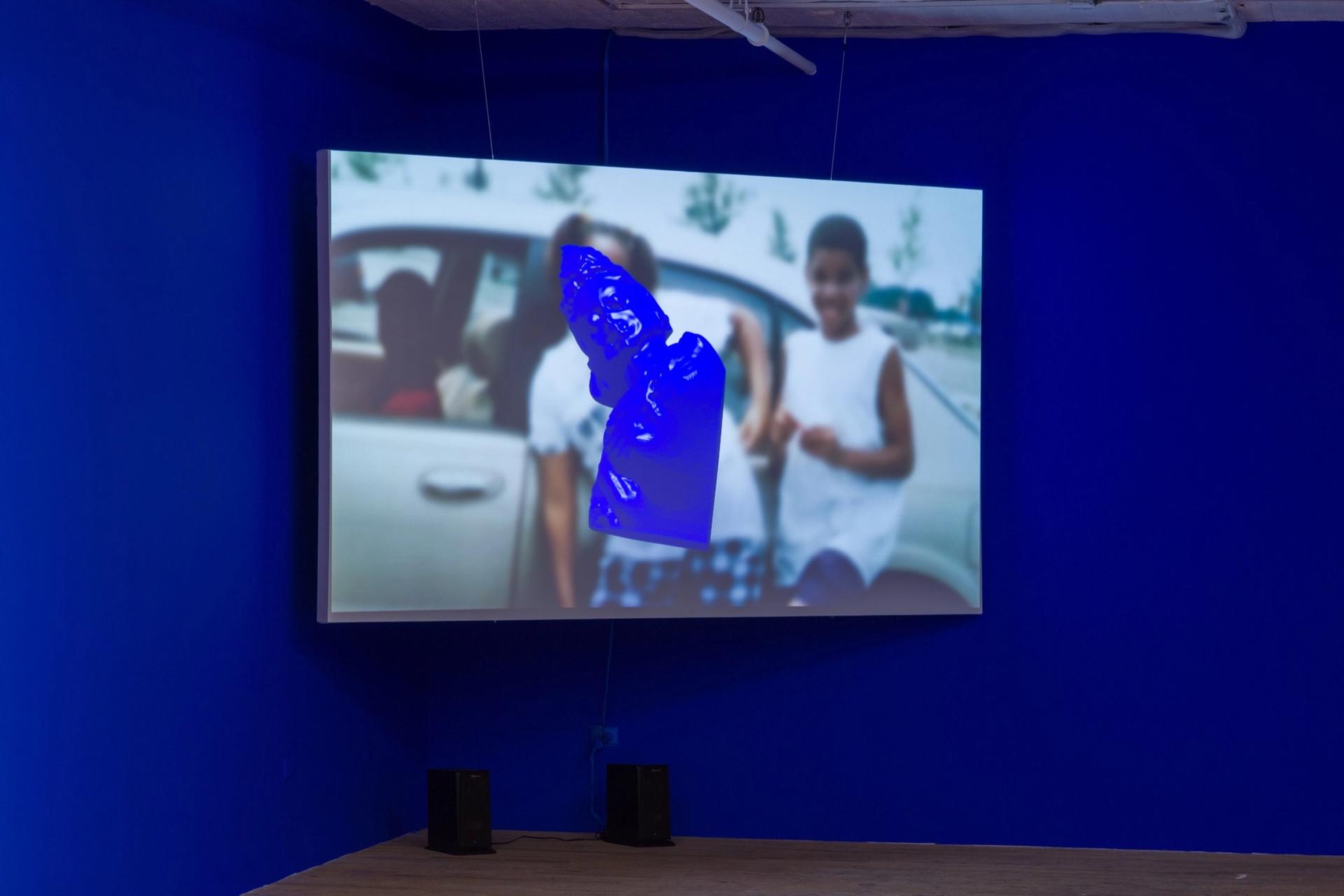 Sondra Perry, "IT’S IN THE GAME ’17 or Mirror Gag for Vitrine and Projection," 2017. HD video and animation: color sound, 17 minutes; Rosco chroma key blue paint. Courtesy of the artist.