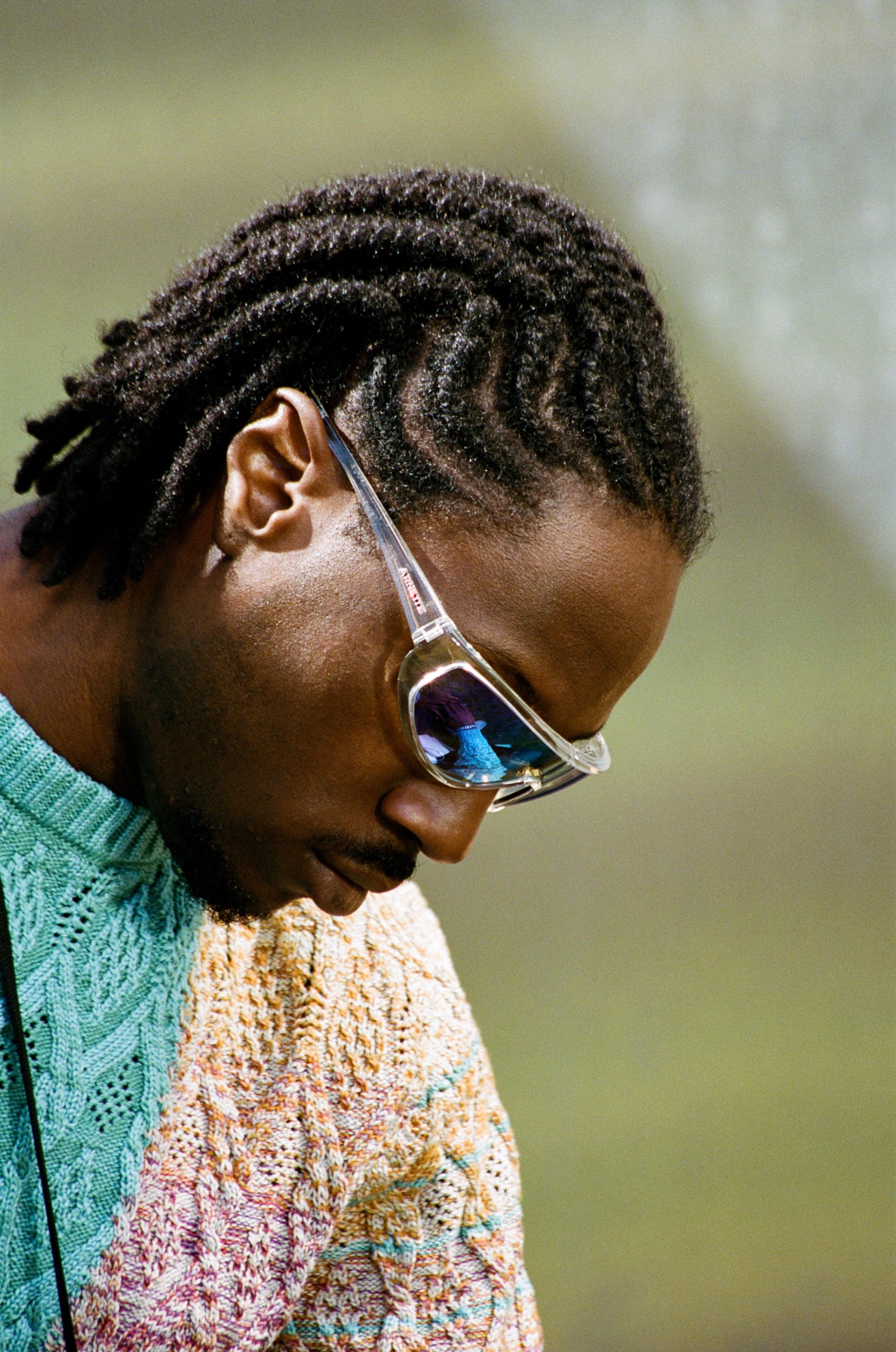 Kwam.e wears a Missoni jumper and Arnette sunglasses