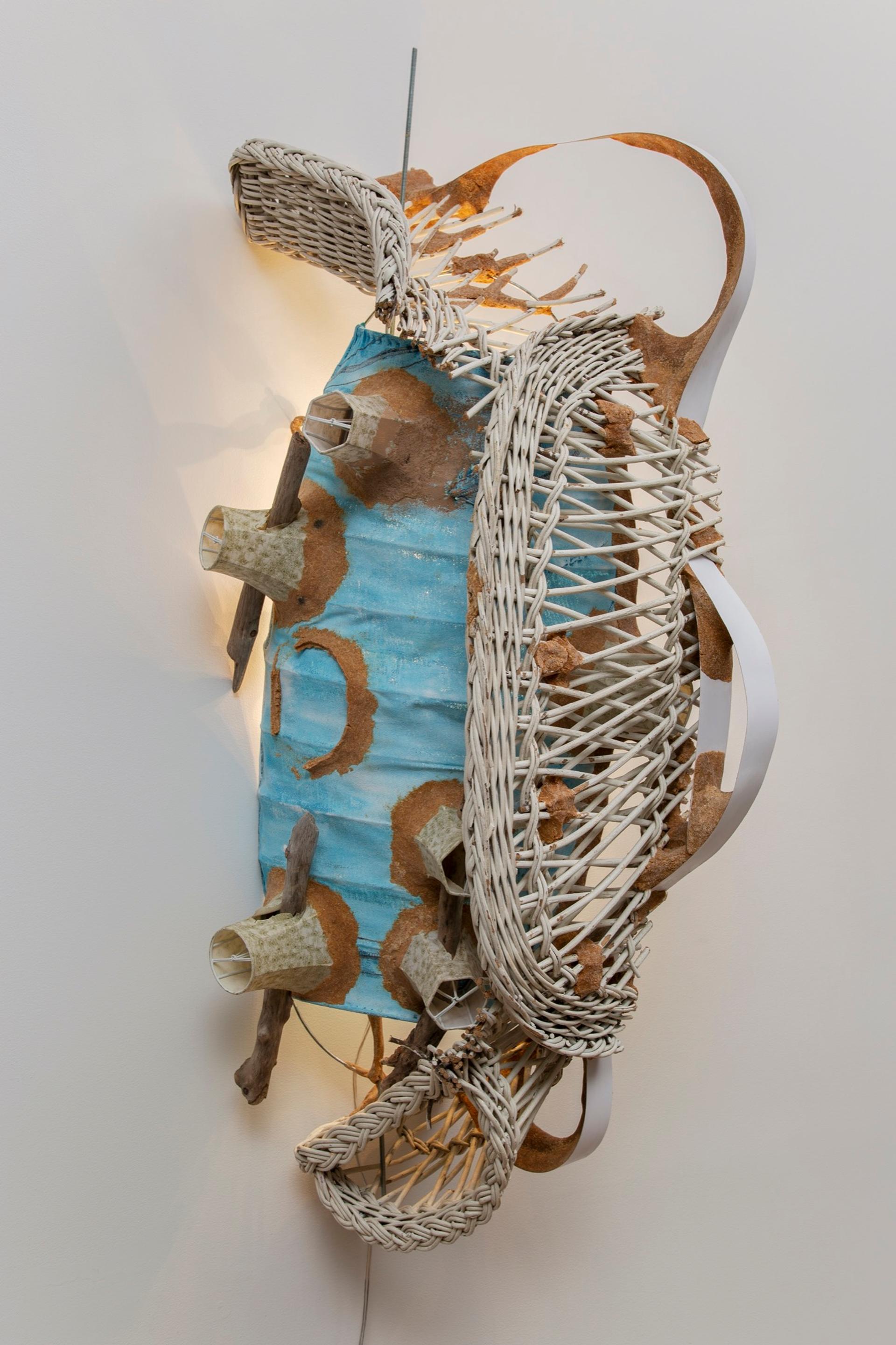 Jessi Reaves, Vicious circle wall lamp, 2019. Wicker, metal, paint, sawdust, woodglue, fabric, driftwood, lamp and wiring 50 × 16 × 23 in. (127.00 × 40.64 × 58.42 cm) Courtesy the artist and Bridget Donahue, NYC. Photo: Gregory Carideo