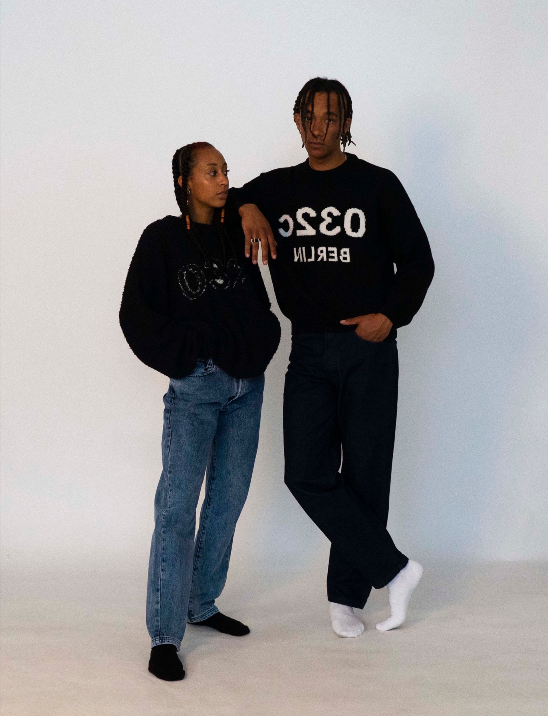 Libell wears the 032c LoveSexDreams Terry logo pullover with the "Next" jeans in light blue. Buyegi wears the "Selfie" knit pullover with the "Next" jeans in dark blue