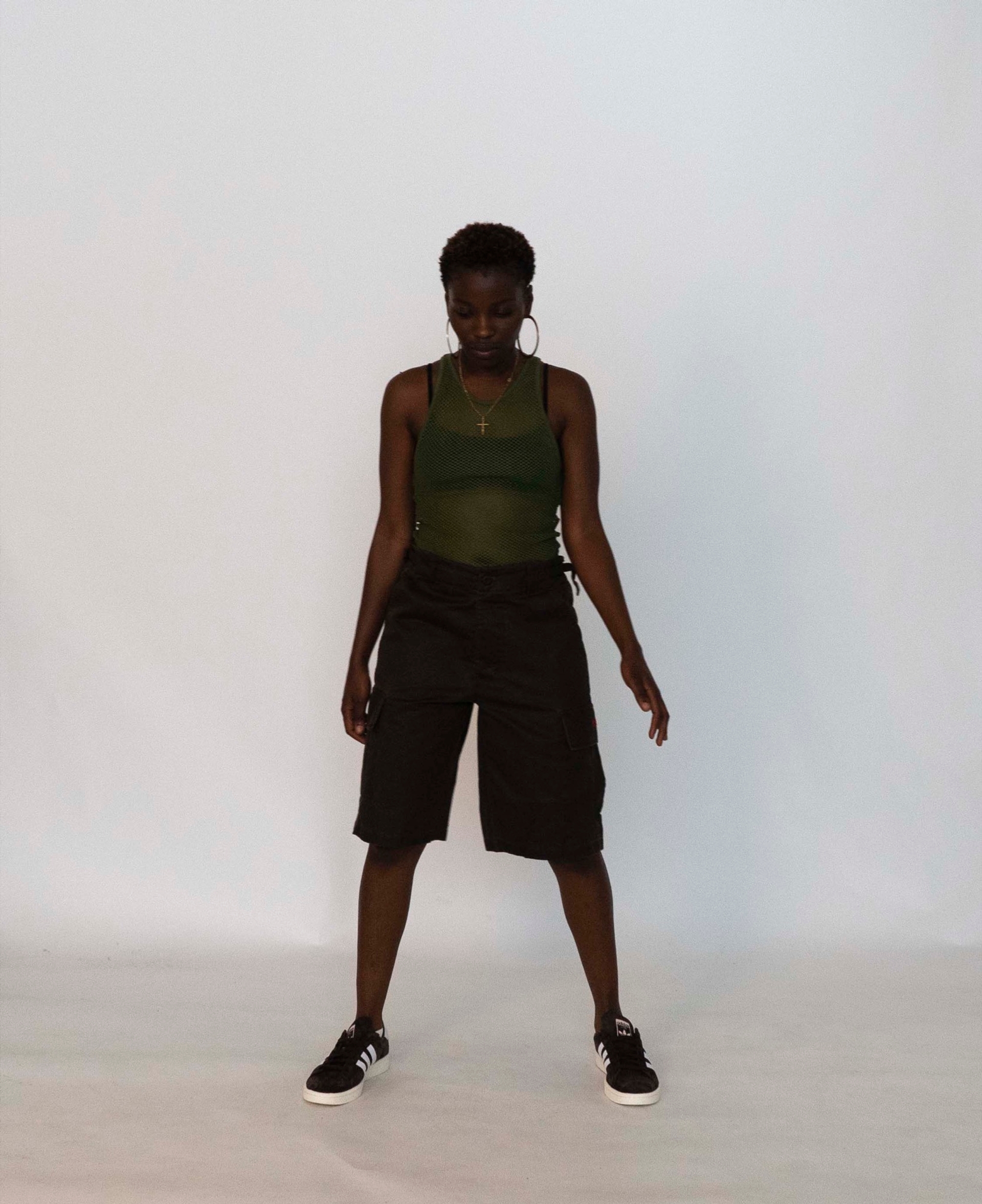 Mariama wears the 032c LoveSexDreams Net Tank in olive with Cargo Shorts