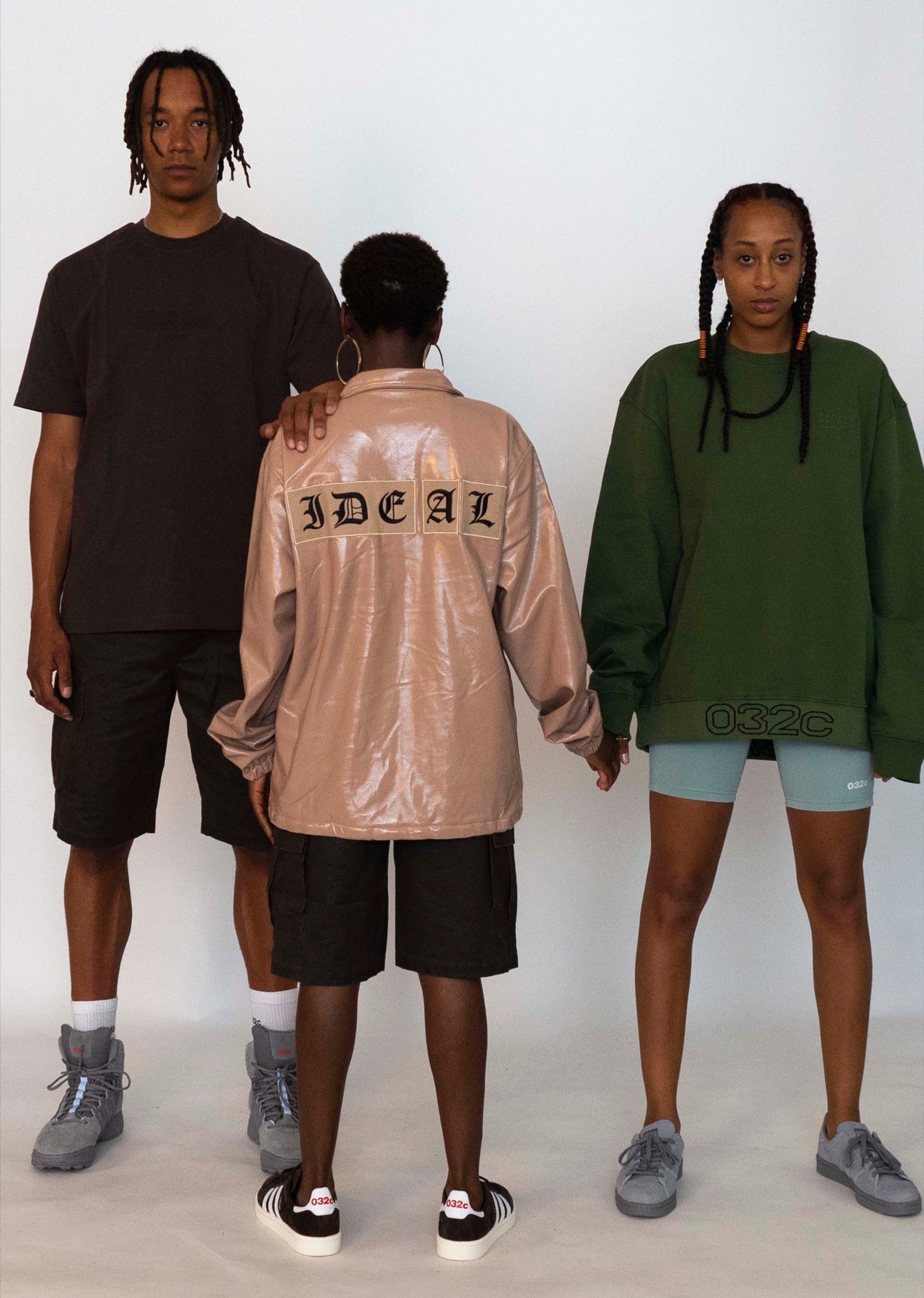 Buyegi wears the 032c LoveSexDreams "FRC" t-shirt in black paired with Cargo Shorts and our 032c x adidas Originals GSG-9High Top Sneaker. Mariama wears the "IDEAL" Coach Jacket in beige and Cargo Shorts. Libell wears the "032c Workshop" Crewneck in olive and neoprene shorts in mint