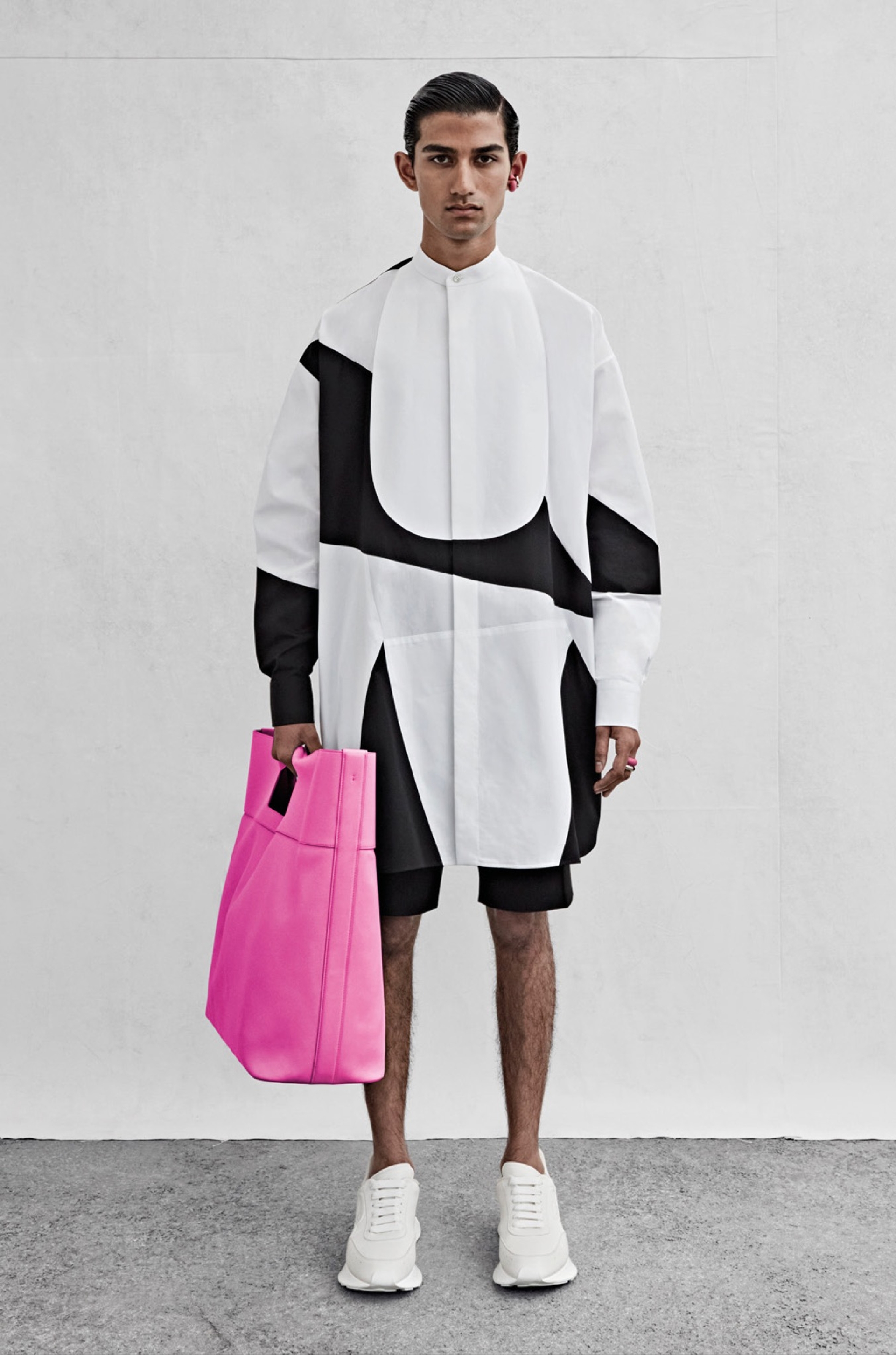 An oversized shirt with a patchwork bib front in white and black cotton poplin and shorts in black cotton canvas.