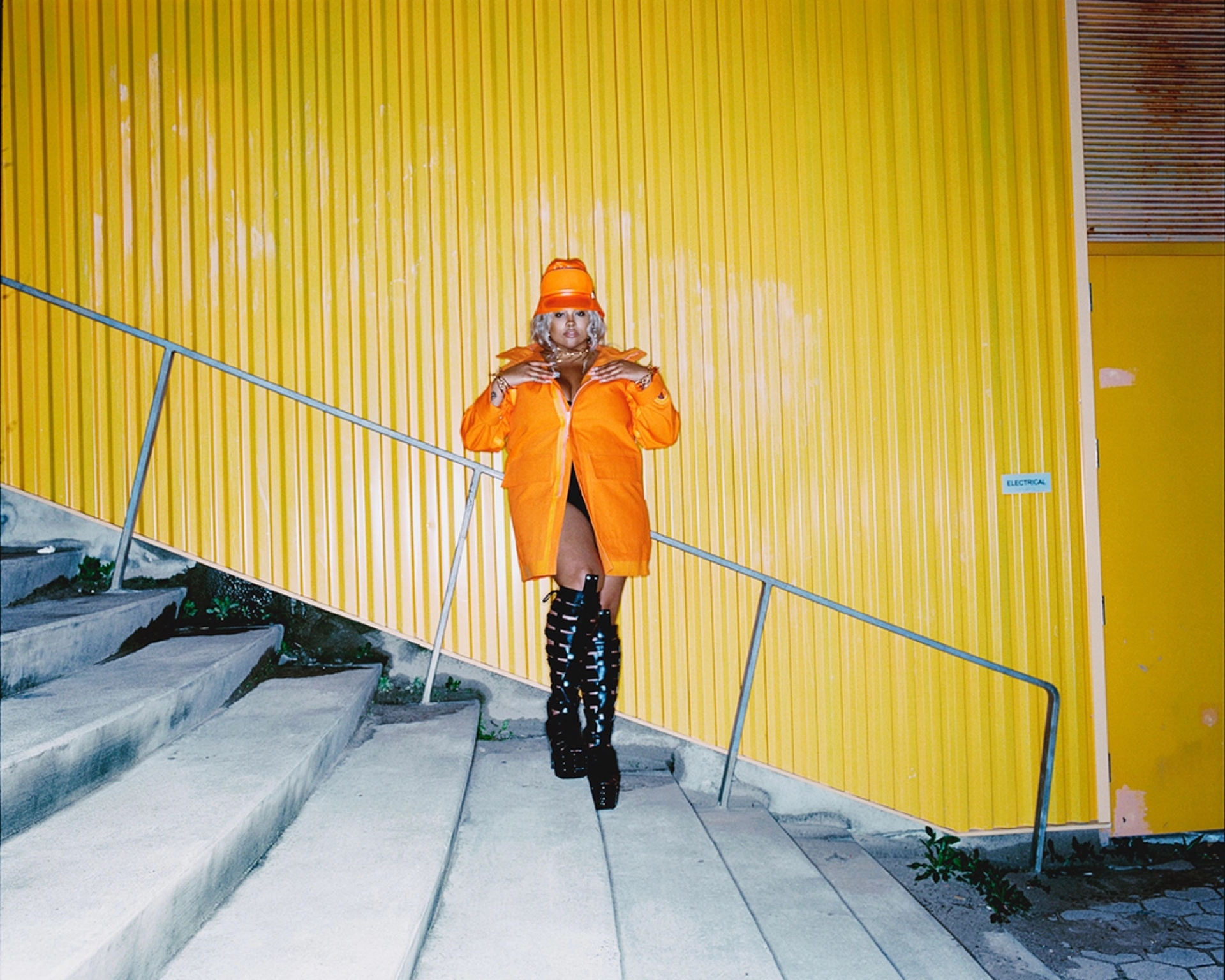 hat and coat BURBERRY; necklace MUGLER; earrings PANCONESI; bodysuit SKIMS; boots RICK OWENS