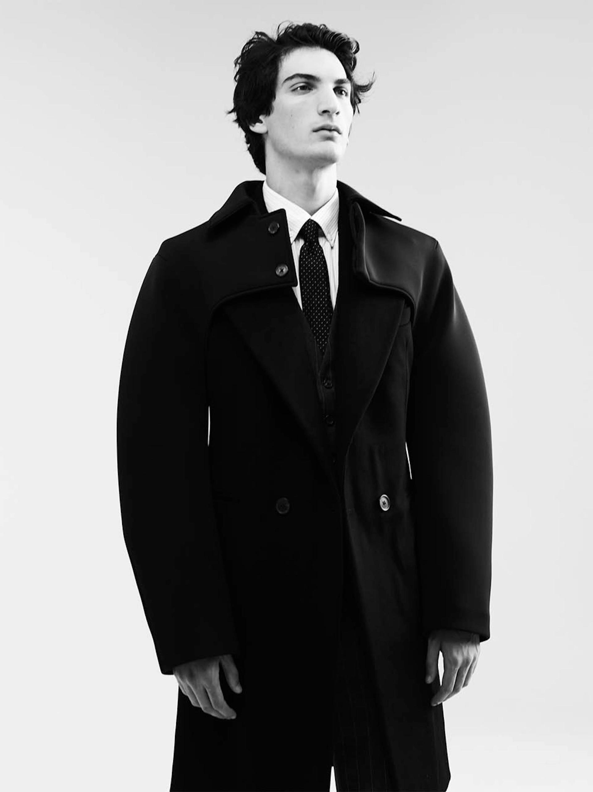 LUCA: cashmere hand-tailored coat, neoprene sleeves with collar, cotton pinstripe shirt, wool pinstripe suit vest and -trousers, silk jacquard tie: RAF SIMONS A/W 2009/2010; silver earring: RAF SIMONS A/W 2003/2004