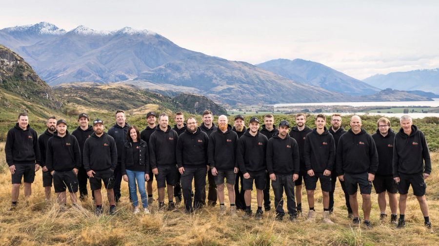 Aotea Plumbing & Drainage team in Central Otago with mountains and a lake behind them