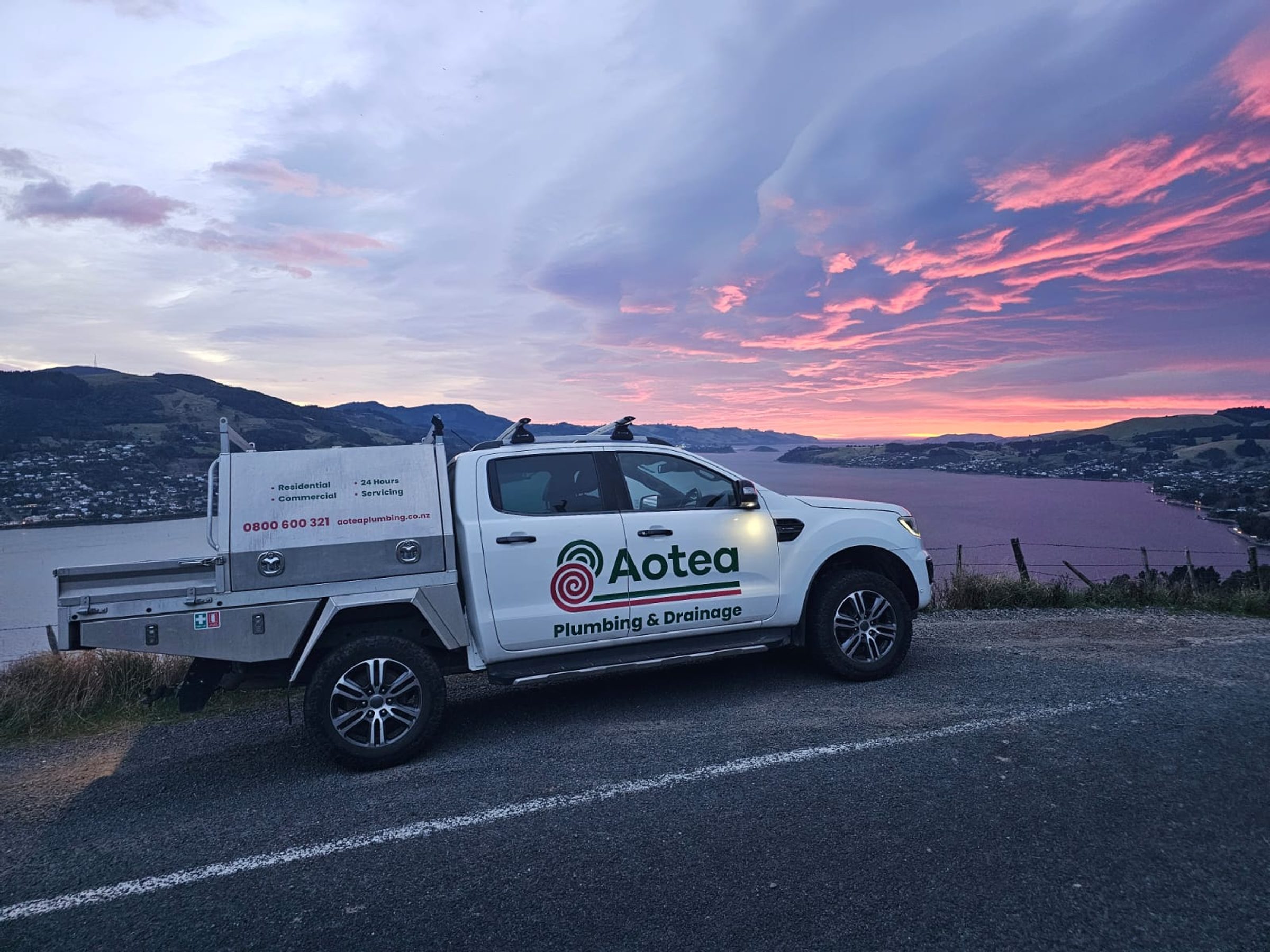 Aotea Plumbing & Drainage service ute overlooking a Central Otago lake at sunset