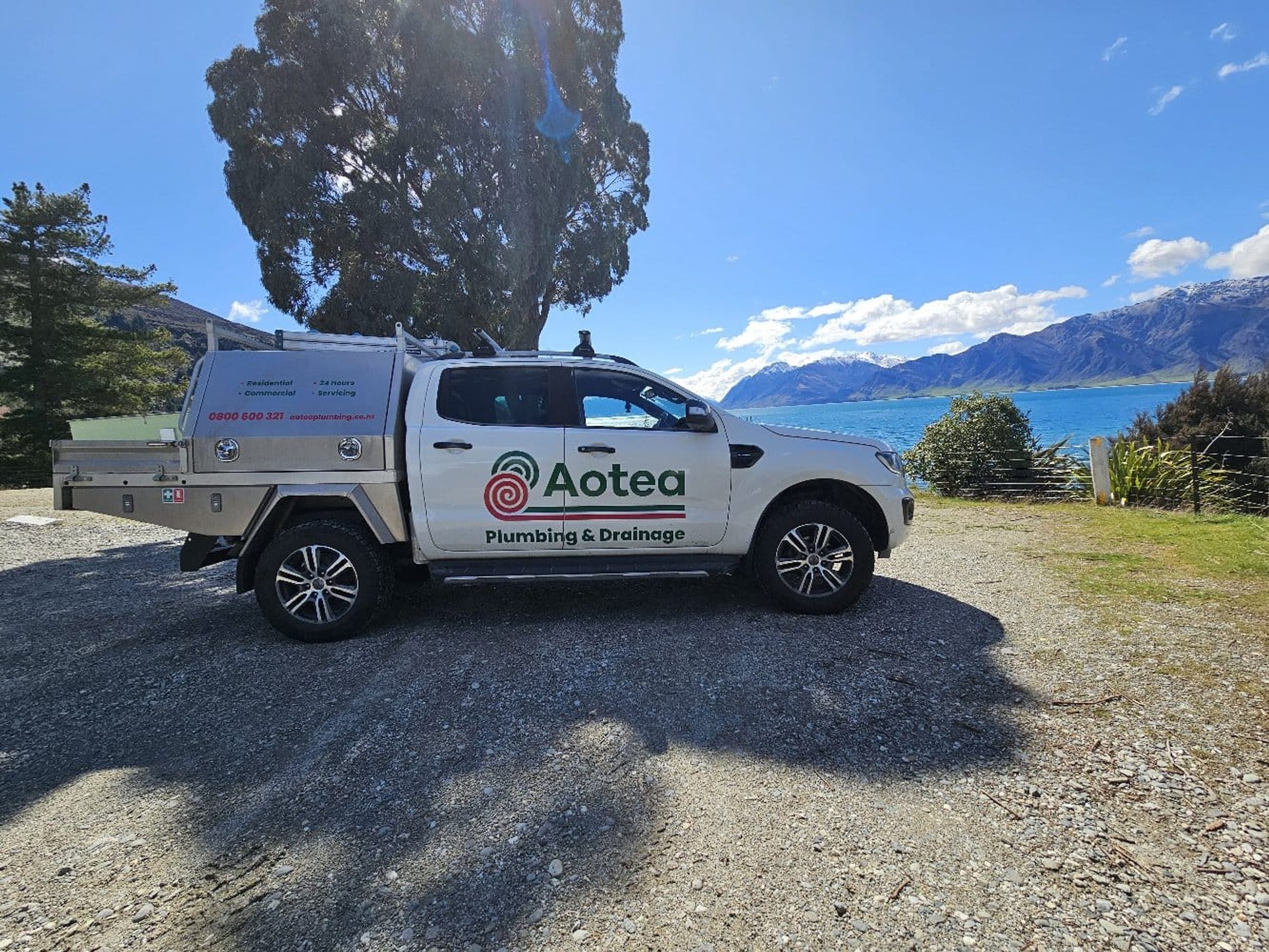 Aotea Plumbing & Drainage service ute beside a Central Otago lake