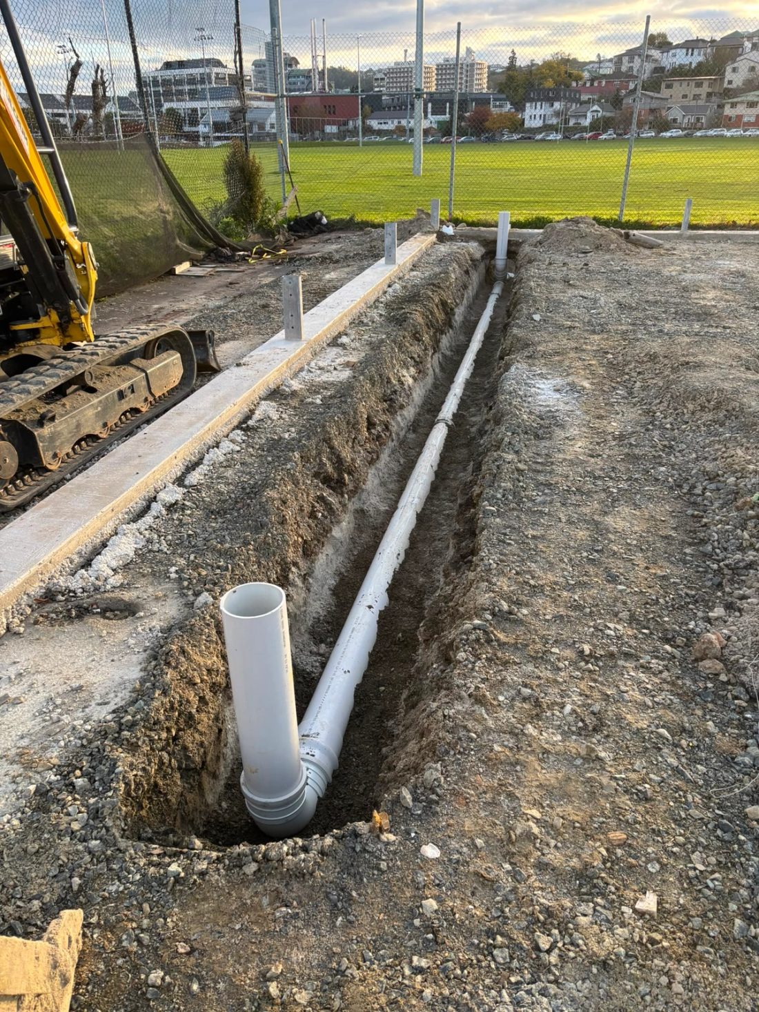 Underground drainage pipes installed in a trench at a construction site