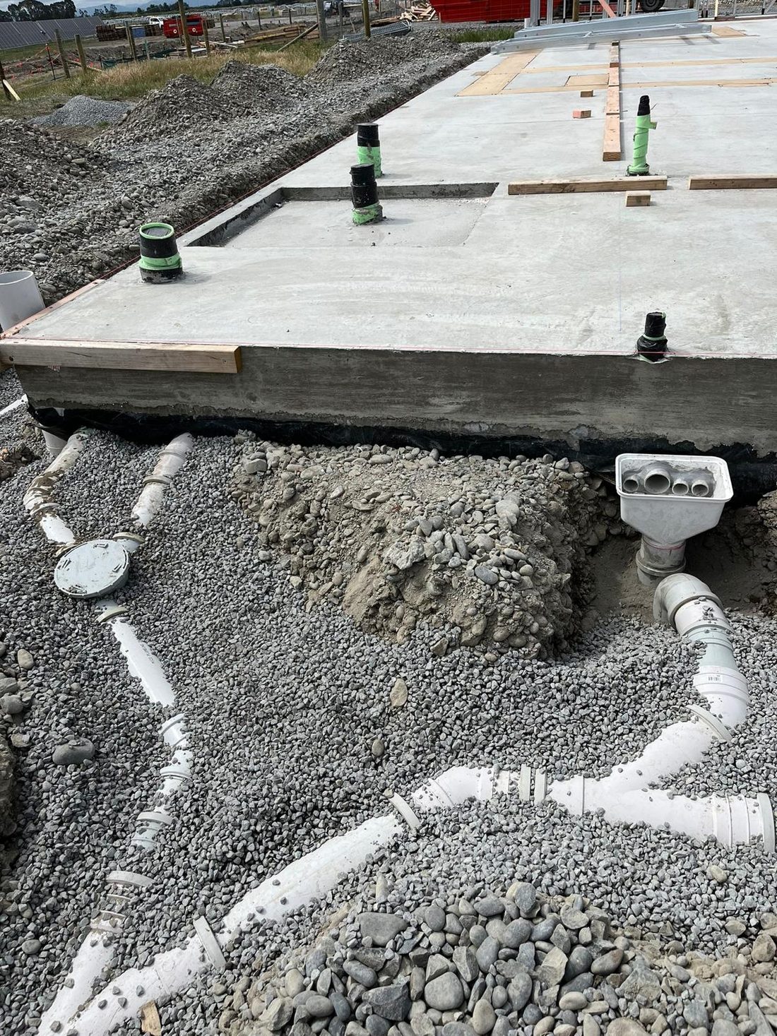 Underground drainage pipework installed beneath a new concrete foundation
