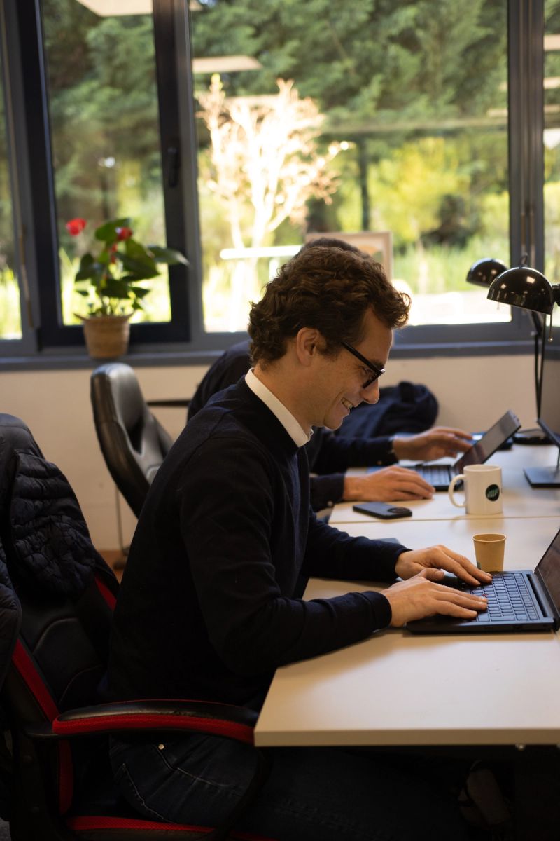 Genomines team member smiling at his desk
