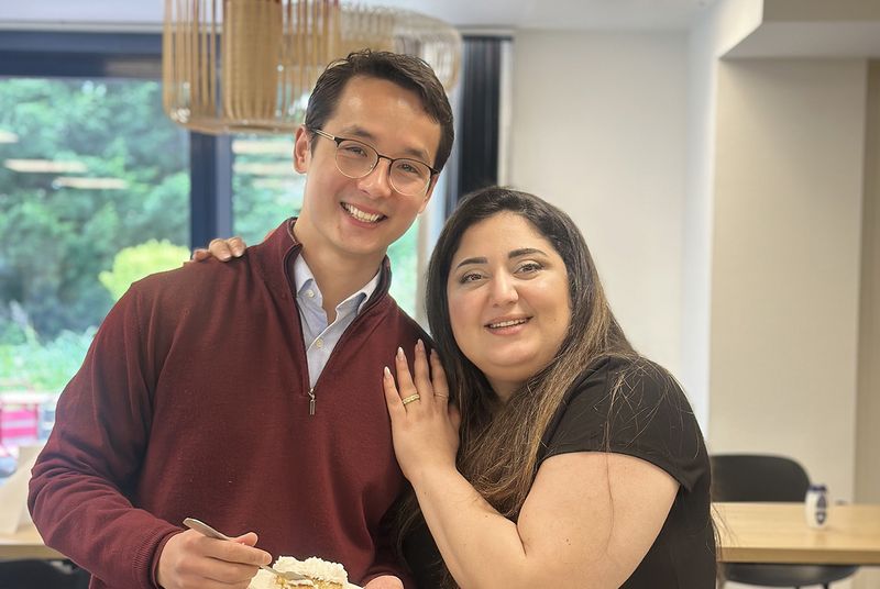 Two Genomines team members sharing a celebration at the office