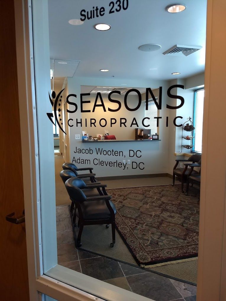 Seasons Chiropractic Clinic Entrance - A view of our welcoming front door and window showcasing the company name, doctor names, and suite number.