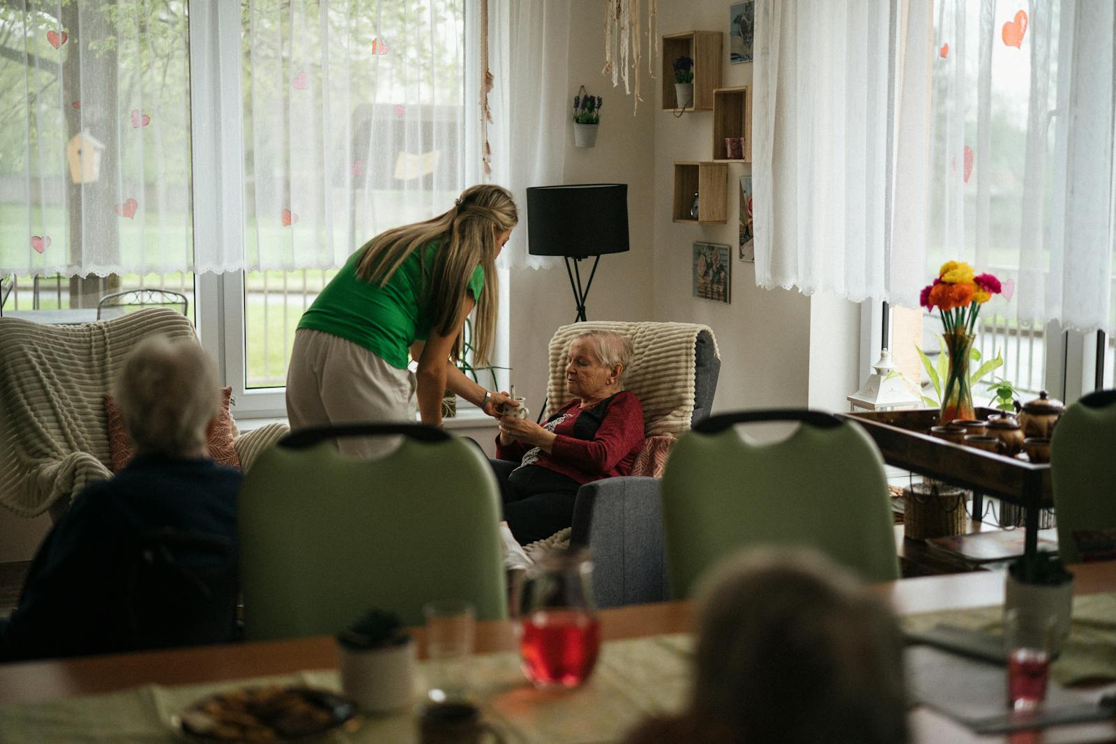 A caregiver supporting an elderly person
