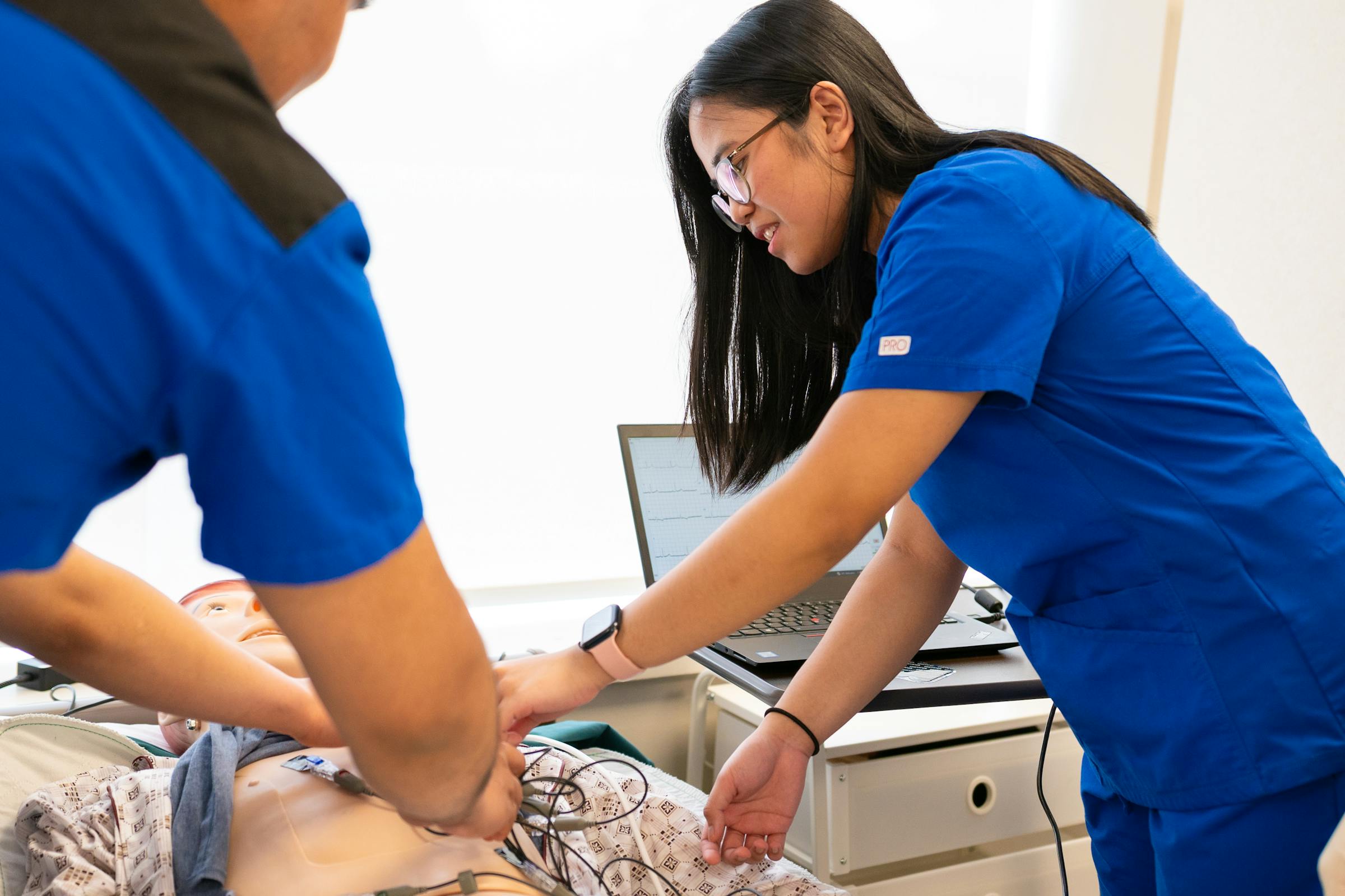 A nursing assistant attending a resident in a care home room