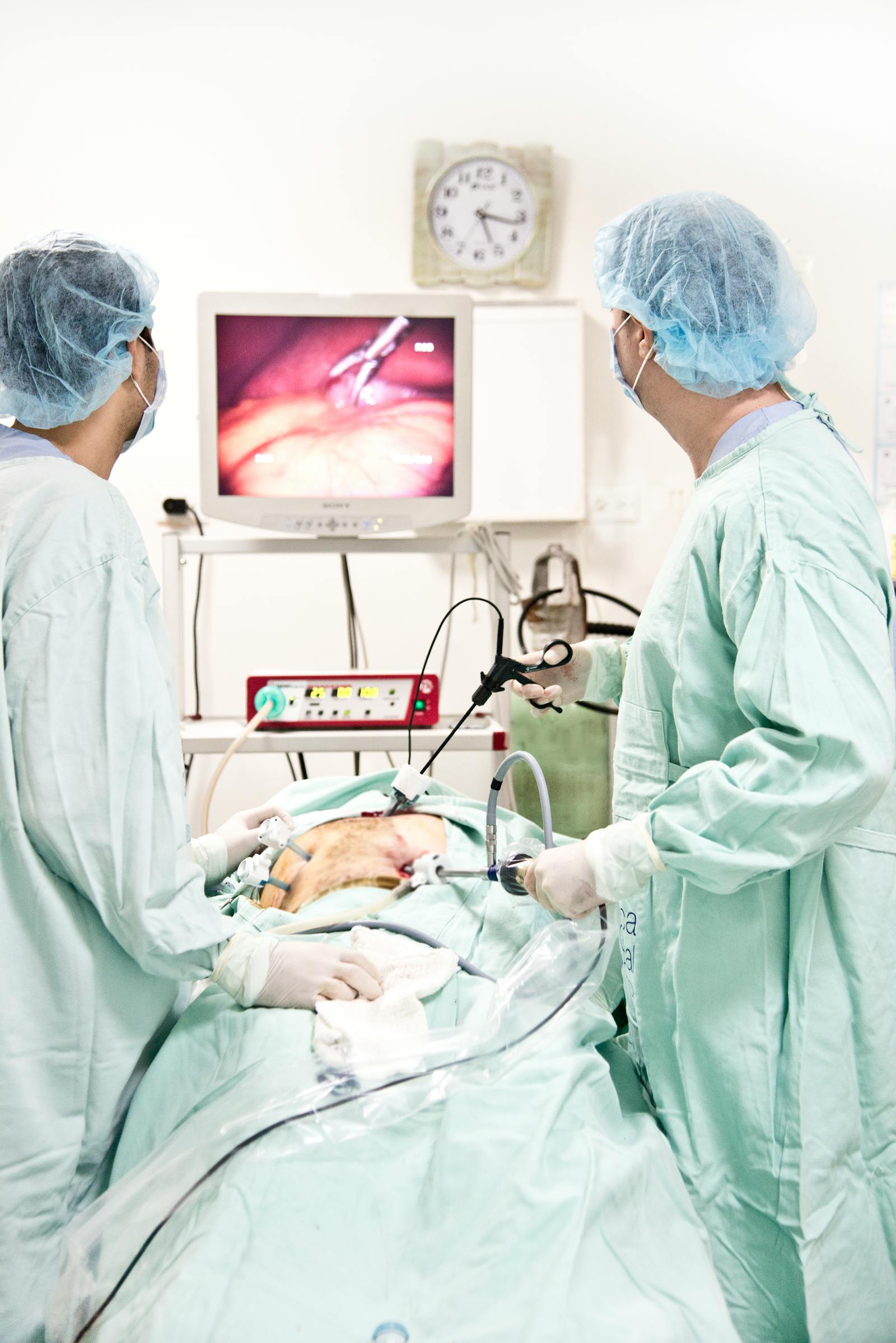 Surgical team performing a minimally invasive operation in a modern operating room
