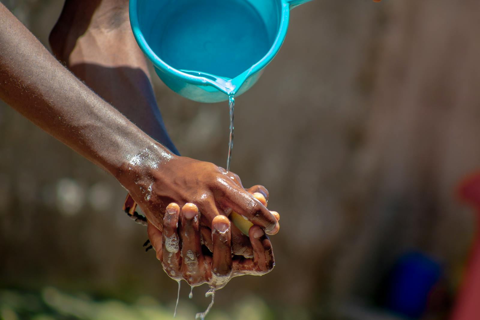 Close-up of hands being washed with soap and water