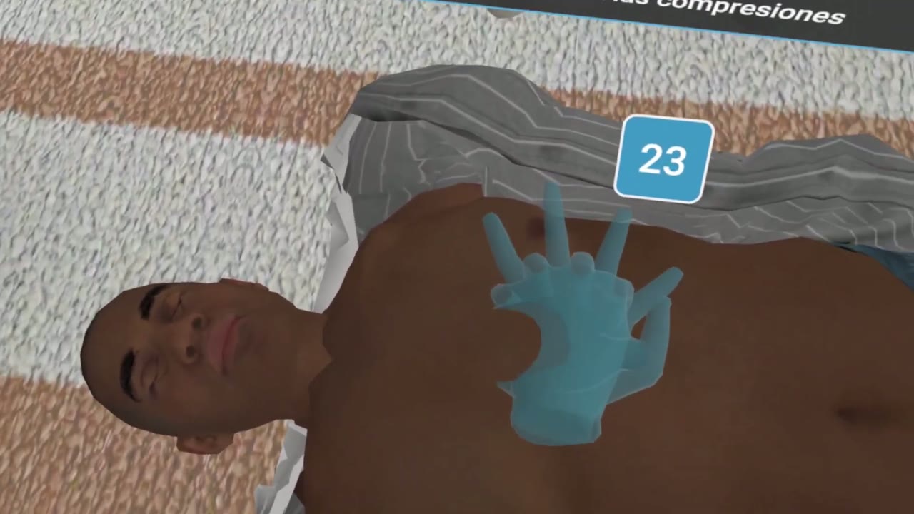 A hand placed on the patient’s chest in the CPR simulation, with the compression counter at 23