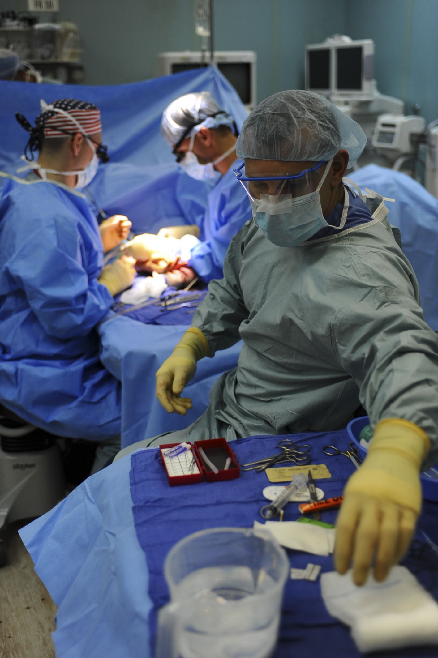 A surgical team performing an operation in a hospital operating room
