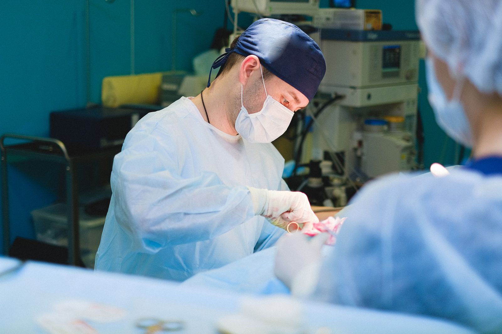 A surgeon's hands working with instruments during a procedure