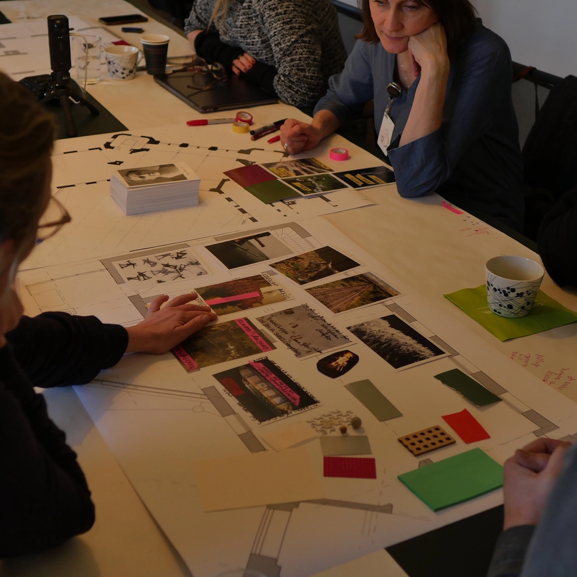a collage being worked on by people at the table.