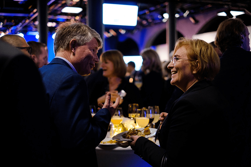 from an event with catering and drinks, two people talking