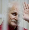 Aljes Bjaljatski waving in jail