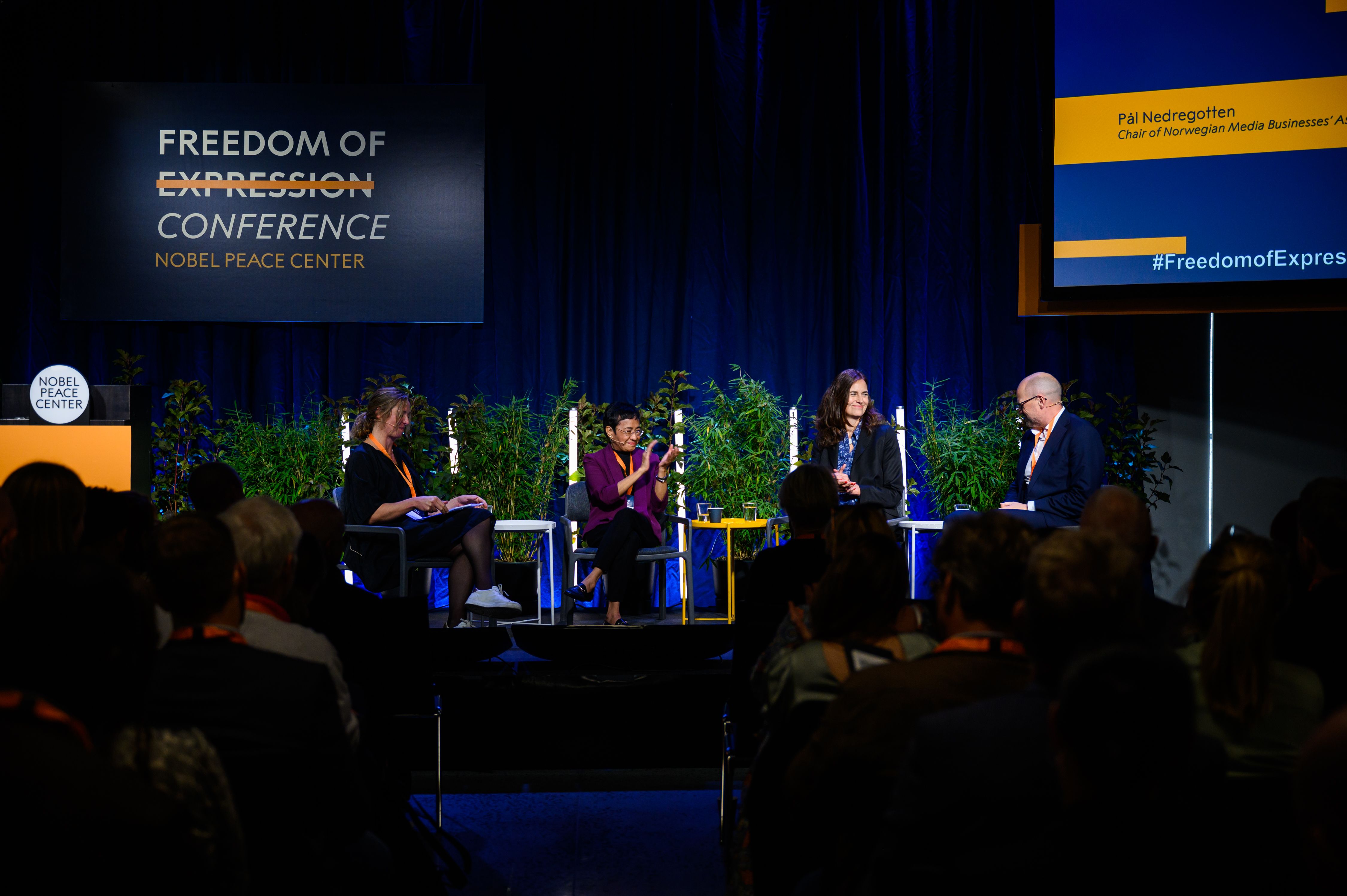 speakers on stage during conference.