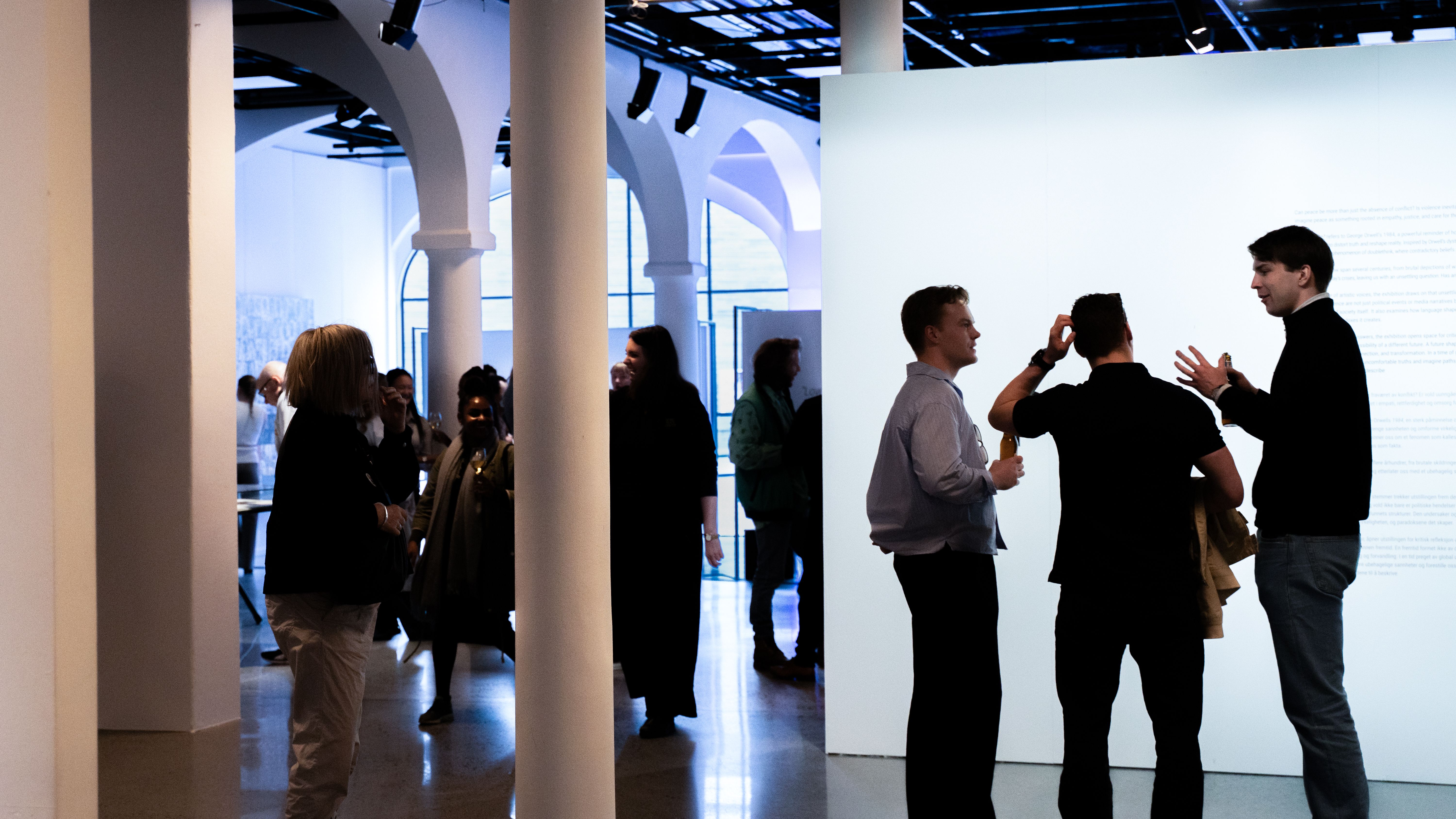 People in an exhibition, socializing.