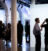 People in an exhibition, socializing.