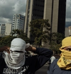 Two men/boys covering their face with tshirts in Venezuela.