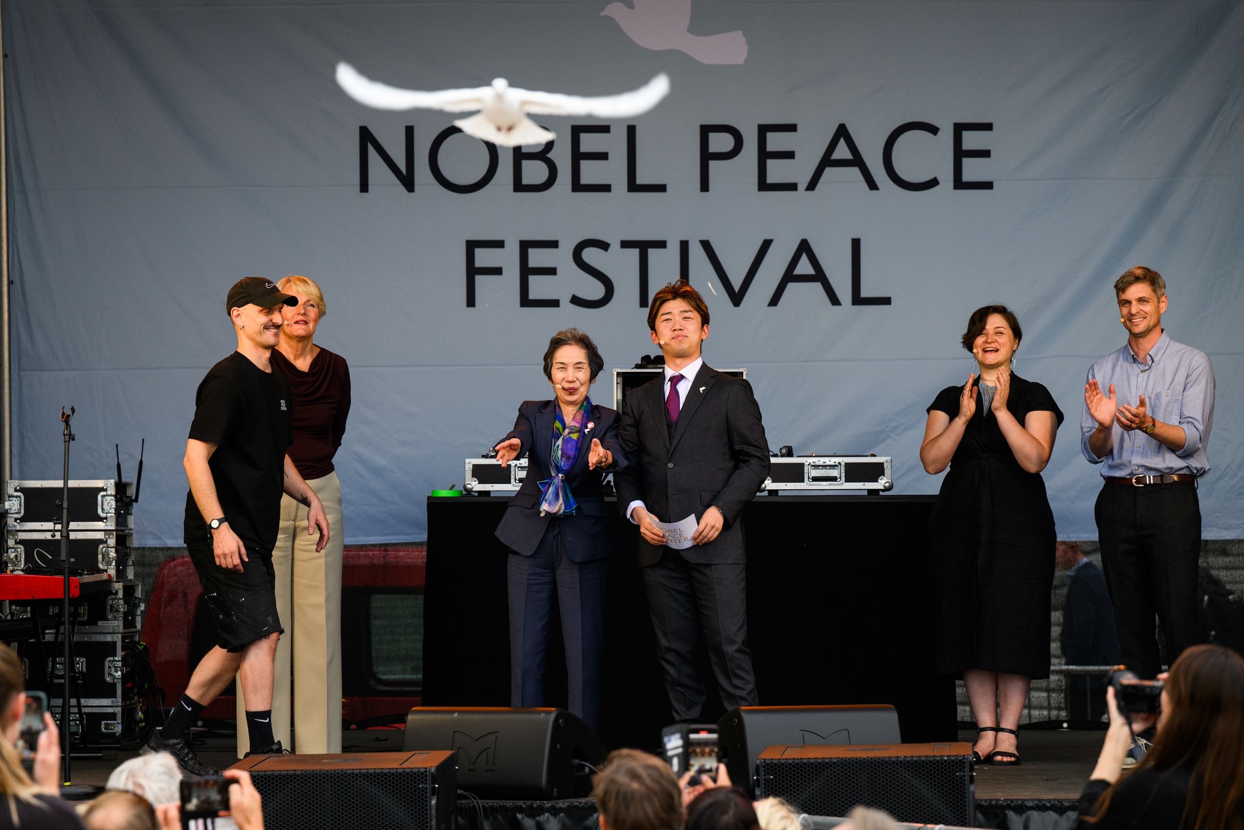 On stage, a peace dove is released.
