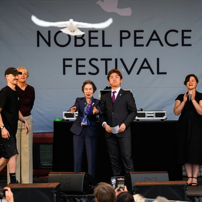 from stage; peace dove being released.